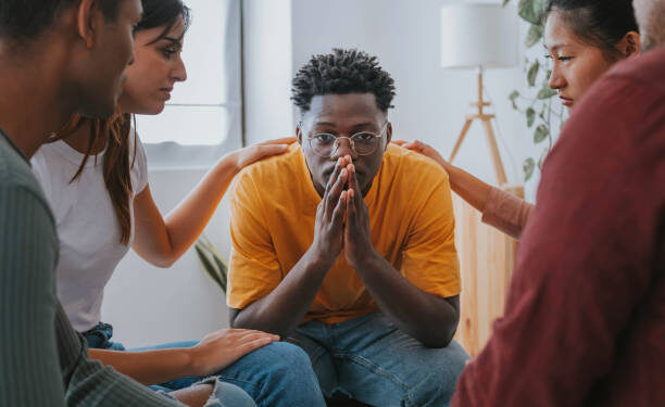 Sad African American guy get psychological support of counselor therapist - Social issue and racism concept